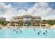 Resort-style pool area with ample seating and a beautiful clubhouse backdrop at 8156 Living Tide Dr., Myrtle Beach, SC 29572