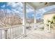 Cozy balcony with white railings, wooden floors, and a view of neighborhood buildings and street at 843 Howard Ave., Myrtle Beach, SC 29577