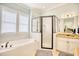 Bright bathroom featuring a soaking tub, glass enclosed shower, granite counters and neutral color palette at 843 Howard Ave., Myrtle Beach, SC 29577