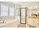 Bright bathroom featuring granite counters, soaking tub, and a glass enclosed shower at 843 Howard Ave., Myrtle Beach, SC 29577