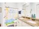 A bathroom with a double vanity and granite counters also has a colorful shower curtain at 843 Howard Ave., Myrtle Beach, SC 29577