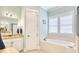 Bright bathroom with a soaking tub, granite counters, and ample natural light from a window at 843 Howard Ave., Myrtle Beach, SC 29577