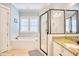 Well-lit bathroom with a glass enclosed shower, granite counters, and a soaking tub under the window at 843 Howard Ave., Myrtle Beach, SC 29577