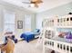 Sunlit bedroom featuring bunkbeds, a twin bed, a ceiling fan and plush decorations at 843 Howard Ave., Myrtle Beach, SC 29577