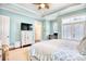 Spacious bedroom featuring a tray ceiling, ceiling fan, TV and a cozy desk nook at 843 Howard Ave., Myrtle Beach, SC 29577