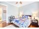 Bright bedroom features a ceiling fan, two bedside lamps, and hardwood flooring with a rug at 843 Howard Ave., Myrtle Beach, SC 29577