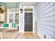 Classic-style front door with a welcoming porch swing, creating an inviting entrance to the home at 843 Howard Ave., Myrtle Beach, SC 29577