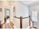 Hallway with hardwood floors and natural light, connecting various rooms on the upper level at 843 Howard Ave., Myrtle Beach, SC 29577