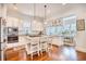 Open-concept kitchen with an island featuring seating, white cabinets, and modern stainless steel appliances at 843 Howard Ave., Myrtle Beach, SC 29577