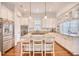 Bright kitchen boasts stainless steel appliances, granite countertops, island seating, and hardwood floors at 843 Howard Ave., Myrtle Beach, SC 29577