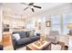 Charming living room showcasing hardwood floors, a ceiling fan, and an open layout leading into the kitchen at 843 Howard Ave., Myrtle Beach, SC 29577