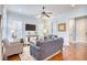 Well-lit living room with a ceiling fan, modern furniture, and a view of the entryway and other rooms at 843 Howard Ave., Myrtle Beach, SC 29577