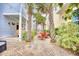 Charming brick patio featuring palm trees and vibrant red seating area between houses at 843 Howard Ave., Myrtle Beach, SC 29577