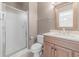 Well-lit bathroom features a glass shower, wood vanity, and framed mirror at 901 West Port Dr. # 1807, North Myrtle Beach, SC 29582