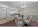 Bright dining area features modern chandelier, neutral paint, and glass-top table with seating for four at 901 West Port Dr. # 1807, North Myrtle Beach, SC 29582