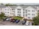 Three-story condo building with white siding, blue shutters and a well-manicured lawn at 901 West Port Dr. # 1807, North Myrtle Beach, SC 29582