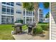 Grilling area with two well-maintained grills, surrounded by landscaping and residential buildings at 901 West Port Dr. # 1807, North Myrtle Beach, SC 29582