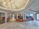 Hallway view of lobby and social area with chandeliers and fireplace at 9650 Shore Dr. # 706, Myrtle Beach, SC 29572