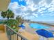 View of the pool with blue umbrellas and the ocean in the background at 9650 Shore Dr. # 706, Myrtle Beach, SC 29572