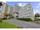 View of building complex with palm trees and nicely manicured lawn at 9840 Queensway Blvd. # 1207, Myrtle Beach, SC 29572