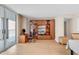 Living room with balcony, featuring wood-look flooring, custom built-in shelving and an ocean view at 9840 Queensway Blvd. # 1207, Myrtle Beach, SC 29572