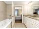 Bathroom view showcasing granite counters, soaking tub, and doorway to bedroom with ocean view at 9994 Beach Club Dr. # 1601, Myrtle Beach, SC 29572