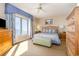 Bright bedroom featuring a large window with ocean view, stylish furnishings, and a ceiling fan at 9994 Beach Club Dr. # 1601, Myrtle Beach, SC 29572