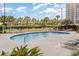 Sparkling pool surrounded by lounge chairs, palm trees, and sunbathers at 9994 Beach Club Dr. # 1601, Myrtle Beach, SC 29572