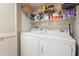 A laundry room featuring a washer, a dryer, storage shelves, and a closet at 101 Ocean Creek Dr. # Dd-9, Myrtle Beach, SC 29572