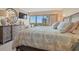 Bright main bedroom with balcony access and views, featuring a large dresser and comfortable bed at 101 Ocean Creek Dr. # Dd-9, Myrtle Beach, SC 29572