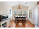 Dining room with modern chandelier, large window views and wood floor at 10-1 Rattan Circle # 1, Pawleys Island, SC 29585