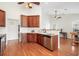 Kitchen featuring wood cabinets, stainless steel appliances, marble backsplash, and hardwood floors at 10-1 Rattan Circle # 1, Pawleys Island, SC 29585