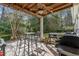 Relaxing covered patio with ceiling fan, stone flooring, and outdoor grilling area at 10-1 Rattan Circle # 1, Pawleys Island, SC 29585