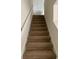 A well lit stairway with carpeted steps and a white handrail leading upstairs at 1025 Carolina Rd. # L-1, Conway, SC 29526