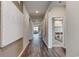 Long hallway with wood floors leads into a bedroom and living room with neutral decor at 1030 Laconic Dr., Myrtle Beach, SC 29588