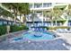 Relaxing outdoor pool area with lounge chairs and mature tropical trees near the building at 1105 S Ocean Blvd. # 336, Myrtle Beach, SC 29577