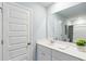 Bright bathroom features a single sink vanity with white quartz countertops and a large mirror at 1150 Blueback Herring Way # 145, Conway, SC 29526