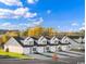 Newly constructed townhomes feature attached garages and modern farmhouse design on a sunny day at 1150 Blueback Herring Way # 145, Conway, SC 29526