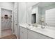 Bright bathroom featuring double sinks, white cabinets, and a doorway to a walk-in closet at 1152 Blueback Herring Way # 144, Conway, SC 29526