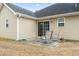 Back patio with seating area and sliding glass door access to the home's interior at 1222 Midtown Village Dr., Conway, SC 29526