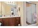 Well-lit bathroom features a glass enclosed shower and vanity with great storage space at 1222 Midtown Village Dr., Conway, SC 29526