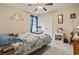 Inviting bedroom showcases a ceiling fan, closet, and light-filled window, creating a cozy and relaxing atmosphere at 1222 Midtown Village Dr., Conway, SC 29526