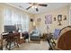 Cozy bedroom features carpeted floors, neutral walls, a ceiling fan, and natural light from sheer-curtained windows at 1222 Midtown Village Dr., Conway, SC 29526