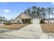 Traditional home features a classic front exterior, attached garage, and a well-maintained lawn with mature landscaping at 1222 Midtown Village Dr., Conway, SC 29526