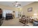 Cozy living room featuring neutral walls, ceiling fan, and a view of the front entrance at 1222 Midtown Village Dr., Conway, SC 29526