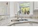 Close up of the stainless steel kitchen sink with granite countertop and window view at 131 Greenside Villas Dr. # B10, Little River, SC 29566