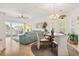 Bright living room with modern furniture, lake views, and plantation shutters on the windows at 131 Greenside Villas Dr. # B10, Little River, SC 29566