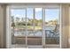 View through sliding glass doors to a balcony featuring a golf course view, table, and chairs at 131 Greenside Villas Dr. # B10, Little River, SC 29566