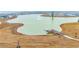 Aerial view of a pond with a fountain and dock in a residential community at 145 Goldenrod Circle # 7B, Little River, SC 29566