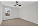 A bright bedroom featuring neutral walls, carpet flooring, and a window at 145 Goldenrod Circle # 7B, Little River, SC 29566